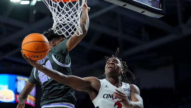 Mar 2, 2024; Cincinnati, Ohio, USA; Cincinnati Bearcats guard Jizzle James (2) drives to the basket against Kansas State Wildcats forward Jerrell Colbert (20) in the first half at Fifth Third Arena. Mandatory Credit: Aaron Doster-USA TODAY Sports